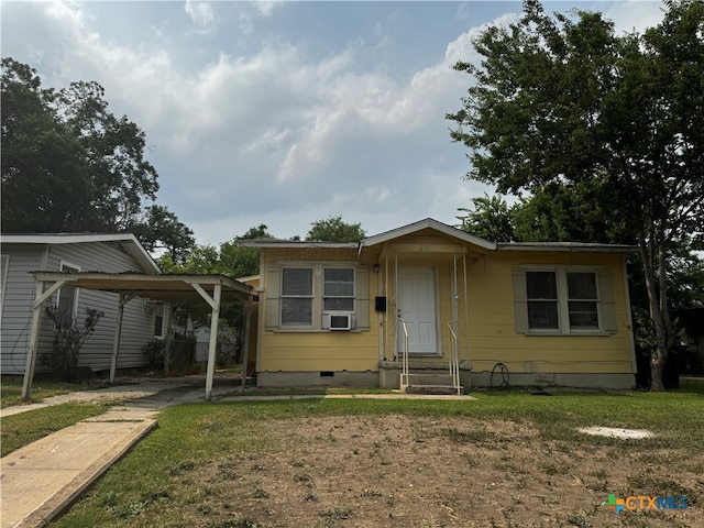 view of front of house with cooling unit and a front lawn