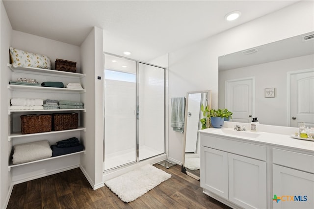 1004 Norway Dr, Seguin, TX 78155 - bathroom with vanity, a stall shower, wood finished floors, and recessed lighting