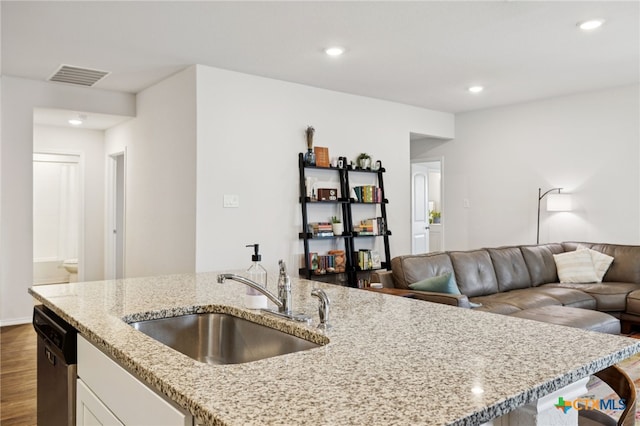 1004 Norway Dr, Seguin, TX 78155 - kitchen with dishwasher, dark wood-style flooring, light stone countertops, white cabinets, and recessed lighting