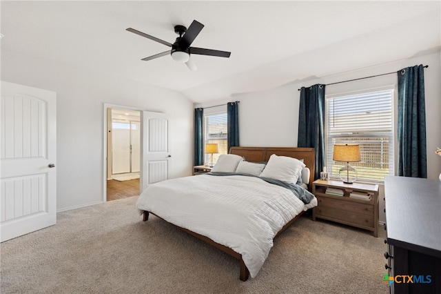 1004 Norway Dr, Seguin, TX 78155 - carpeted bedroom featuring multiple windows, vaulted ceiling, a ceiling fan, and connected bathroom
