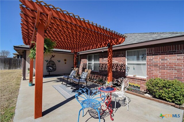 view of patio / terrace featuring a pergola and fence