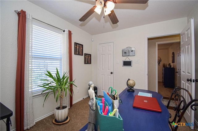 interior space with carpet flooring, baseboards, and ceiling fan