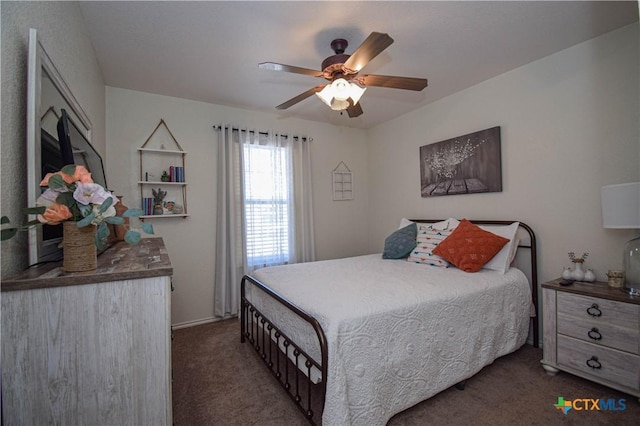 bedroom with a ceiling fan and carpet