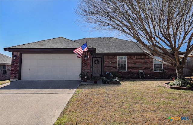 view of front facade featuring driveway, roof with shingles, an attached garage, a front lawn, and brick siding