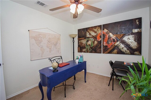 office space with carpet flooring, baseboards, visible vents, and ceiling fan