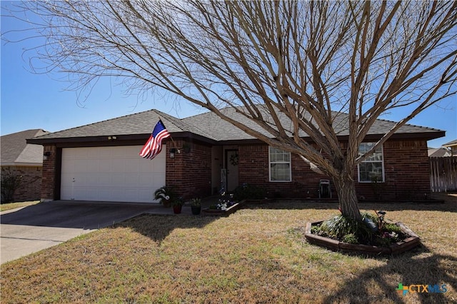 ranch-style house featuring fence, driveway, a front lawn, a garage, and brick siding