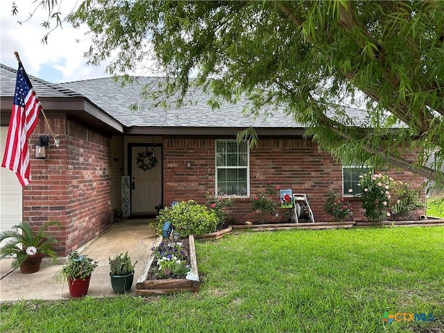 306 Viola Dr, Killeen, TX 76542 - entrance to property with a yard, a shingled roof, and brick siding
