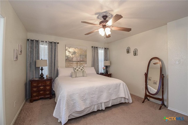 carpeted bedroom with baseboards and ceiling fan