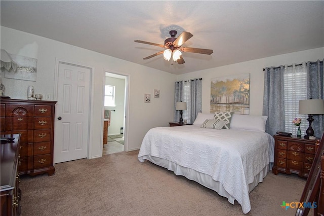 bedroom featuring carpet flooring, a ceiling fan, and ensuite bathroom