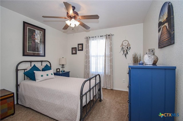 carpeted bedroom featuring baseboards and ceiling fan