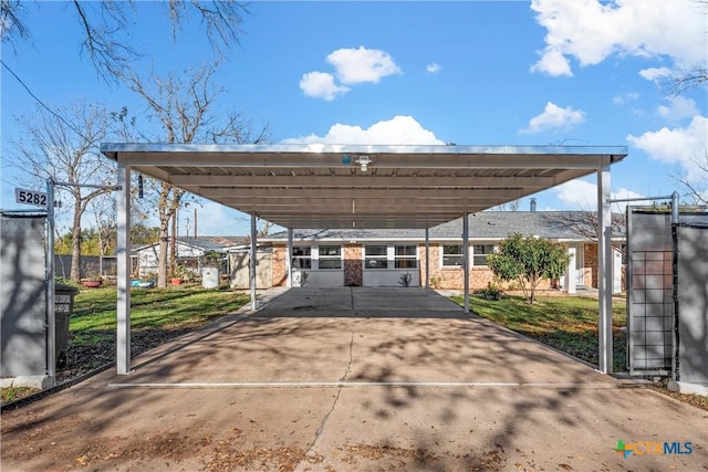 view of car parking with a yard and a carport