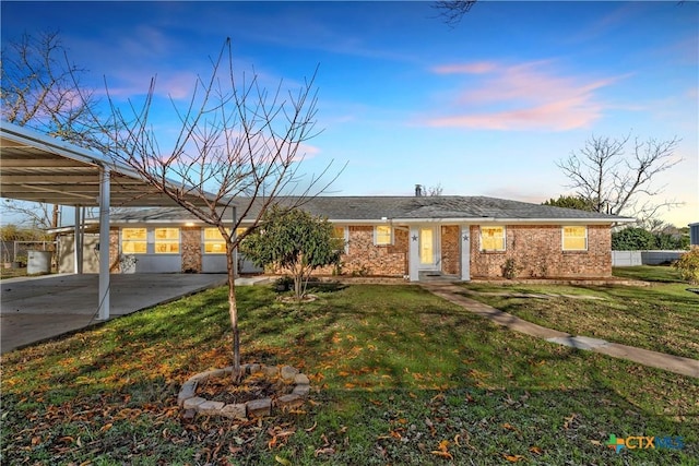 ranch-style home featuring a yard and a carport