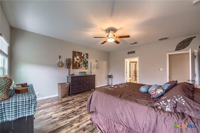 bedroom featuring wood finished floors, visible vents, baseboards, and ceiling fan