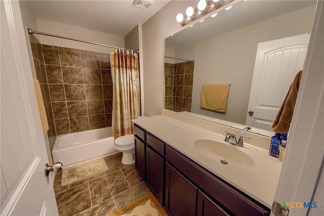 bathroom featuring visible vents, toilet, vanity, stone finish flooring, and shower / bath combo with shower curtain