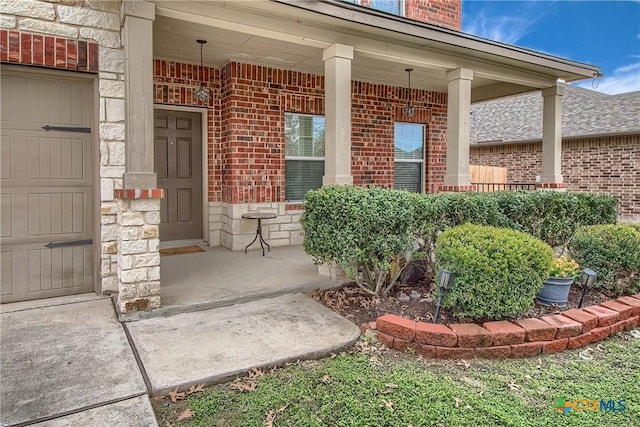 entrance to property with stone siding, covered porch, and brick siding