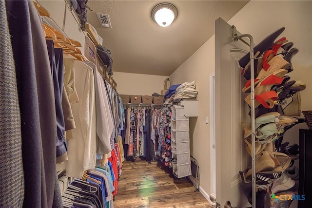 spacious closet featuring wood finished floors and visible vents
