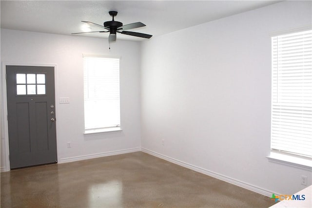 entrance foyer featuring ceiling fan and plenty of natural light