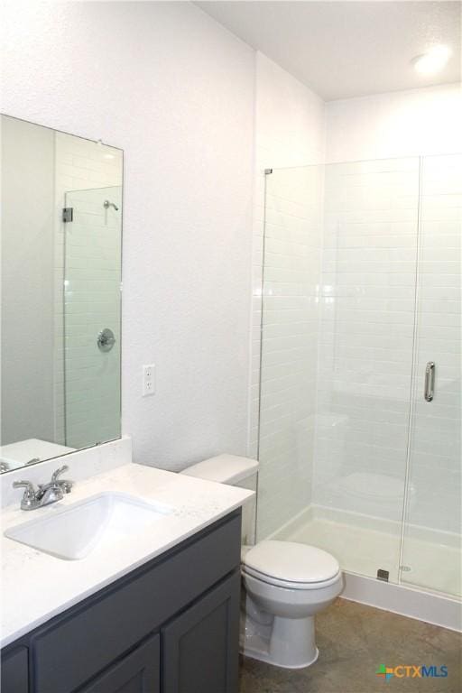 bathroom with tile patterned floors, toilet, an enclosed shower, and vanity