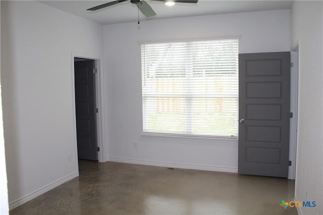 empty room featuring ceiling fan and a healthy amount of sunlight