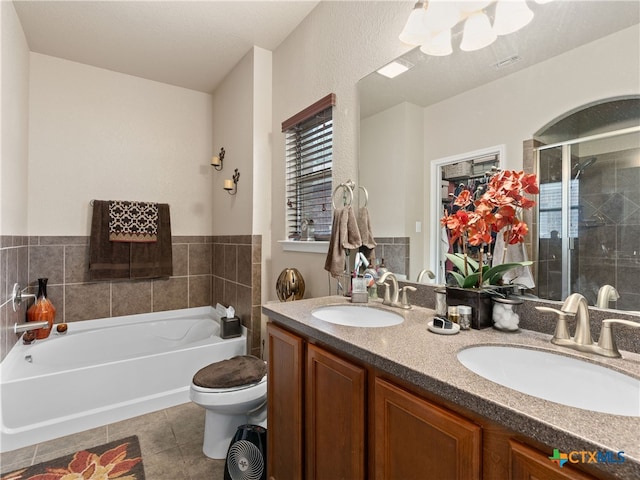 9823 Amberg Path, Helotes, TX 78023 - bathroom with a bath, double vanity, a stall shower, and tile patterned flooring
