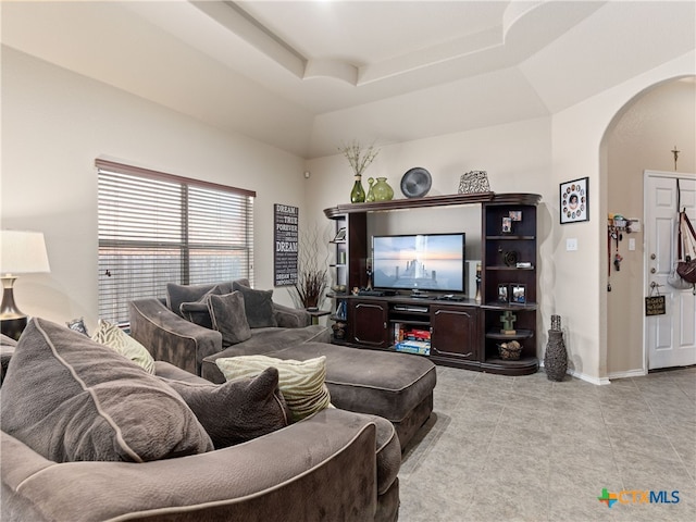 9823 Amberg Path, Helotes, TX 78023 - tiled living room featuring arched walkways and a raised ceiling