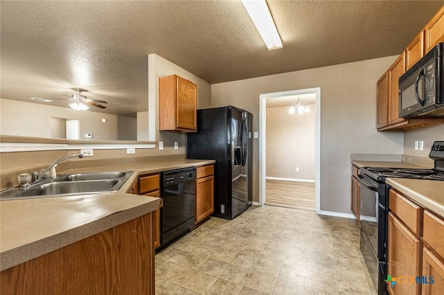 kitchen with sink, ceiling fan with notable chandelier, black appliances, and a textured ceiling