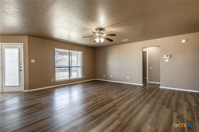 unfurnished living room with ceiling fan, a textured ceiling, and dark wood-type flooring