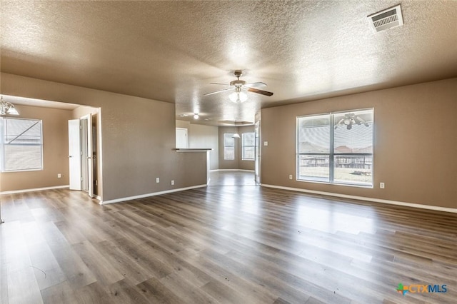 unfurnished living room with wood-type flooring, a textured ceiling, and ceiling fan