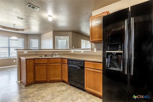 kitchen featuring black appliances, sink, a textured ceiling, decorative light fixtures, and kitchen peninsula