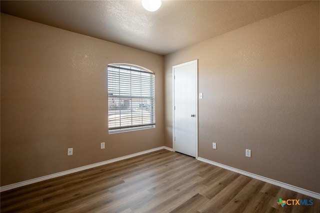 unfurnished room featuring wood-type flooring