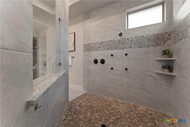 bathroom with tiled shower