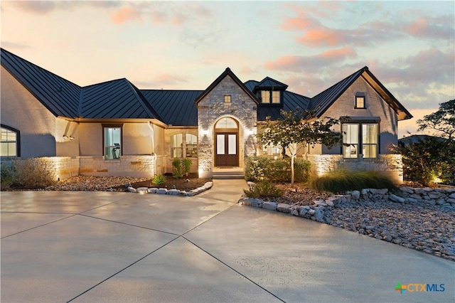 632 Carson Rdg, New Braunfels, TX 78132 - view of front of house with a standing seam roof, stone siding, and metal roof
