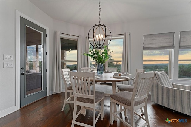 dining room featuring dark hardwood / wood-style flooring and a chandelier