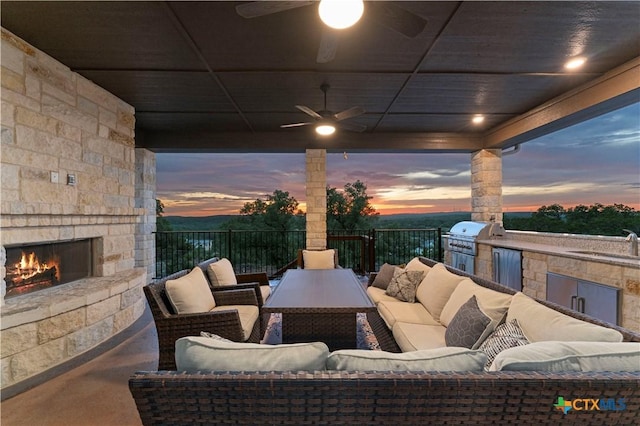 632 Carson Rdg, New Braunfels, TX 78132 - patio terrace at dusk with an outdoor living space with a fireplace, ceiling fan, and a sink