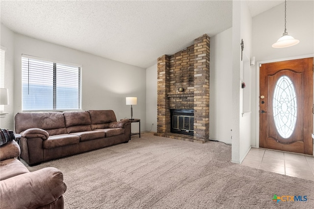 carpeted living room with lofted ceiling, a fireplace, a textured ceiling, and a wealth of natural light