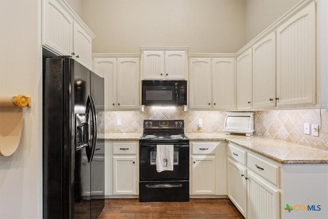 13 Mojave Ln, Belton, TX 76513 - kitchen featuring black appliances, decorative backsplash, dark wood-style flooring, and light stone countertops