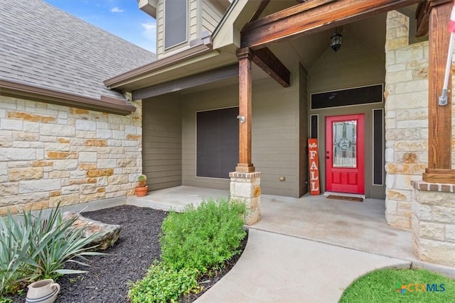 13 Mojave Ln, Belton, TX 76513 - view of exterior entry featuring stone siding, a shingled roof, and a porch