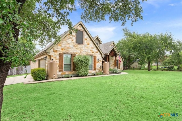 13 Mojave Ln, Belton, TX 76513 - tudor-style house with stone siding, a garage, and driveway