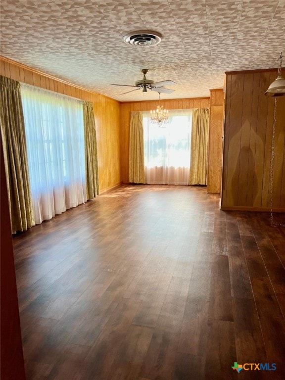 6414 Fm 234 N, Edna, TX 77957 - unfurnished room with a chandelier, dark wood-style floors, and wood walls