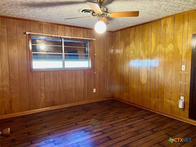 6414 Fm 234 N, Edna, TX 77957 - spare room with wood-type flooring, ceiling fan, wooden walls, and baseboards
