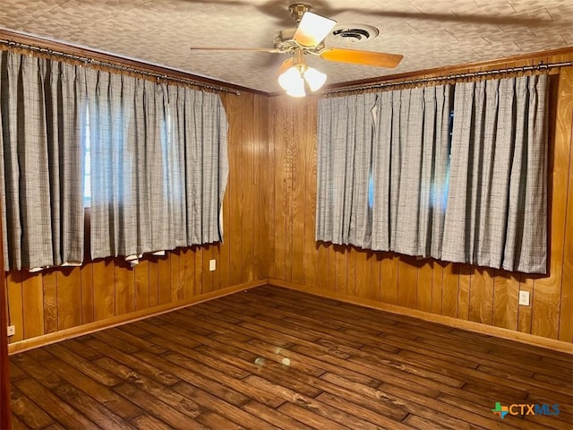 6414 Fm 234 N, Edna, TX 77957 - spare room with a ceiling fan, baseboards, hardwood / wood-style floors, and wooden walls