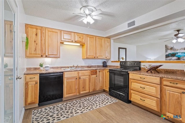 kitchen with black appliances, ceiling fan, light wood-style flooring, a textured ceiling, and a sink