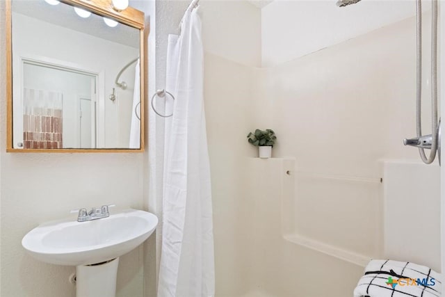 bathroom featuring a sink and curtained shower