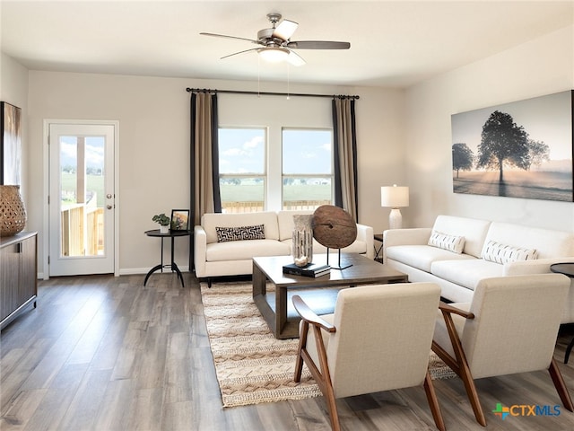 living room with hardwood / wood-style floors and ceiling fan