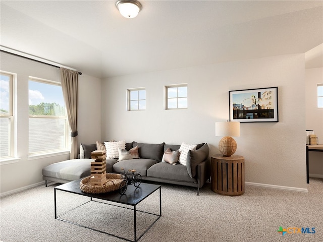 living room with a wealth of natural light and light colored carpet