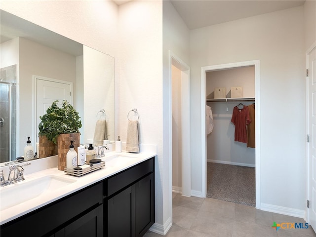 bathroom with walk in shower, vanity, and tile patterned floors