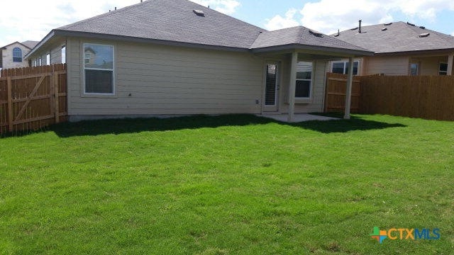 rear view of property with a yard