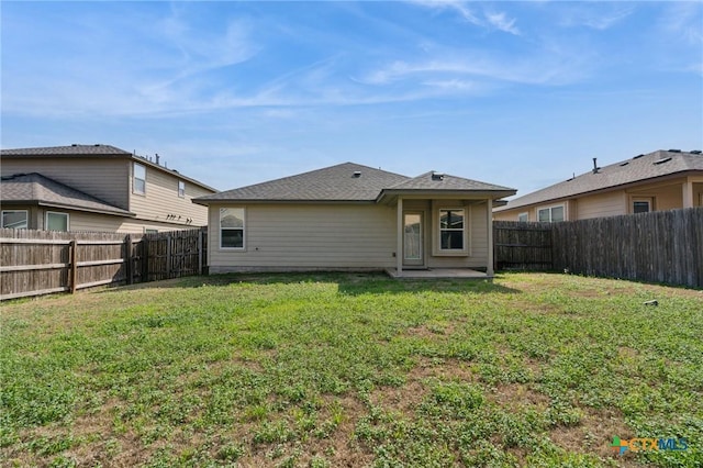 back of house featuring a yard and a patio area