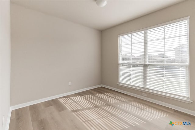 unfurnished room with hardwood / wood-style floors