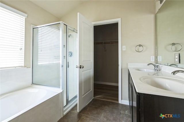 bathroom featuring vanity, tile patterned floors, and plus walk in shower